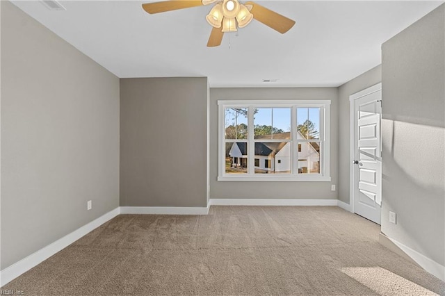 spare room with ceiling fan and light carpet