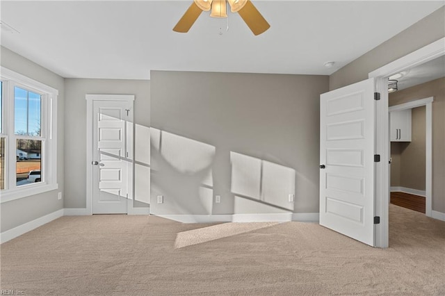 unfurnished room featuring light colored carpet and ceiling fan