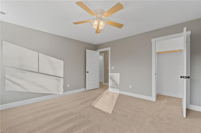 unfurnished bedroom with ceiling fan, light carpet, and a closet