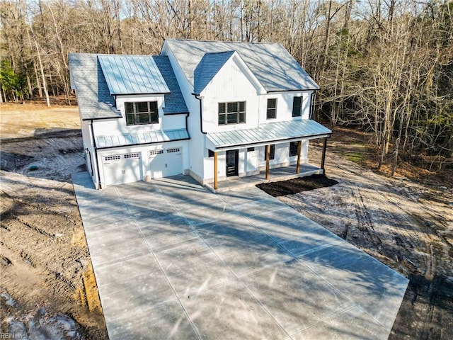 view of front of property with covered porch and a garage