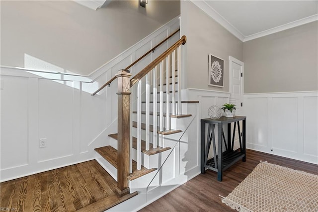 staircase with hardwood / wood-style floors and ornamental molding