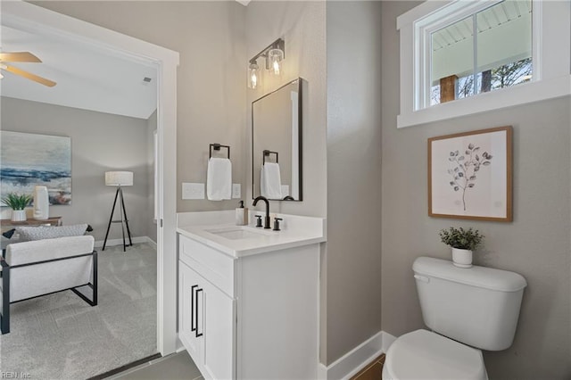 bathroom with ceiling fan, vanity, and toilet