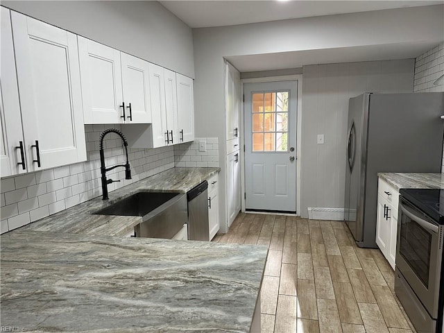 1049 Brandon Ave, Norfolk, VA 23507 - kitchen with stainless steel appliances, light stone countertops, backsplash, and light wood-style flooring