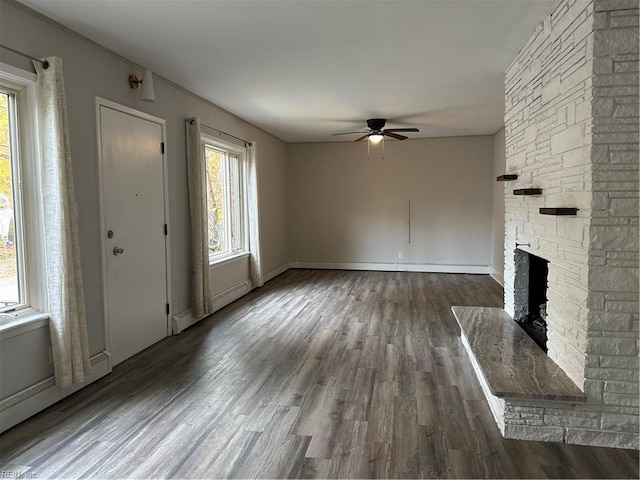 1049 Brandon Ave, Norfolk, VA 23507 - unfurnished living room with a ceiling fan, dark wood-type flooring, a stone fireplace, and a baseboard heating unit