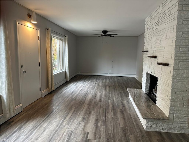 1049 Brandon Ave, Norfolk, VA 23507 - unfurnished living room with a ceiling fan, dark wood-style flooring, and a stone fireplace