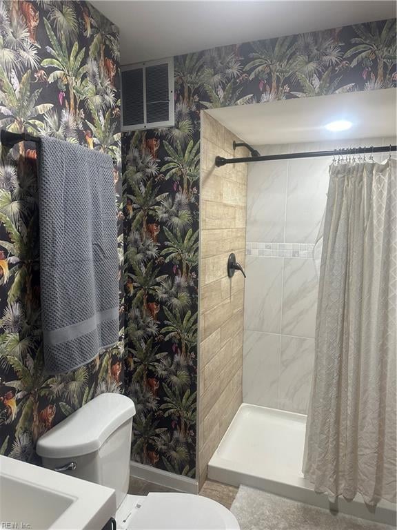 bathroom featuring toilet and walk in shower