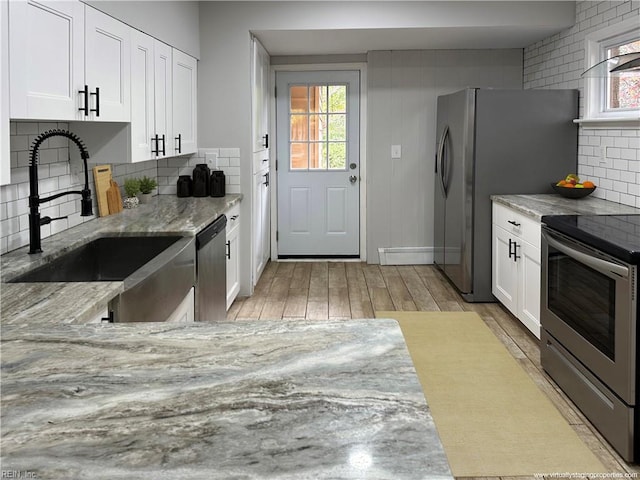 1049 Brandon Ave, Norfolk, VA 23507 - kitchen with stainless steel appliances, light stone counters, and healthy amount of natural light