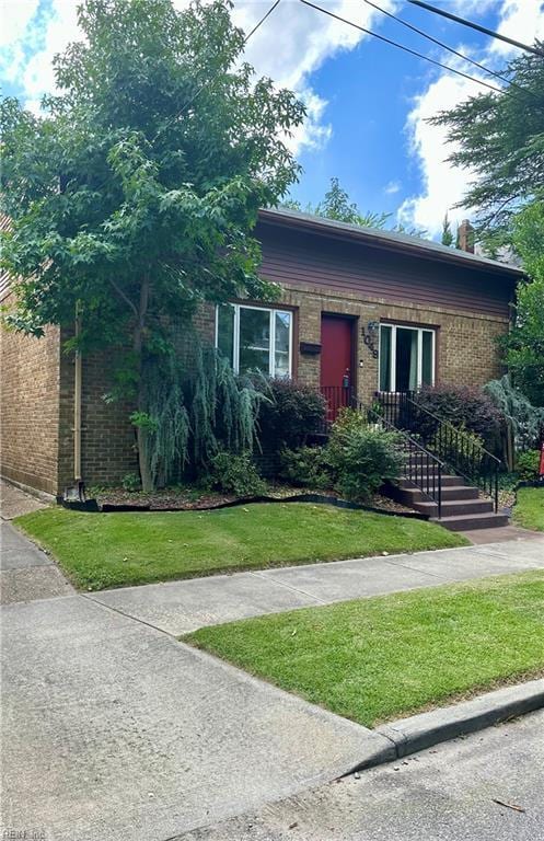 1049 Brandon Ave, Norfolk, VA 23507 - view of property hidden behind natural elements featuring brick siding, a front yard, and a chimney