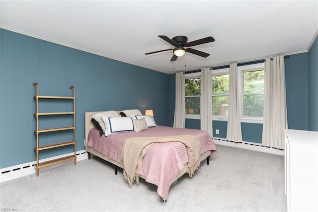 bedroom with carpet flooring, a baseboard heating unit, ceiling fan, and crown molding