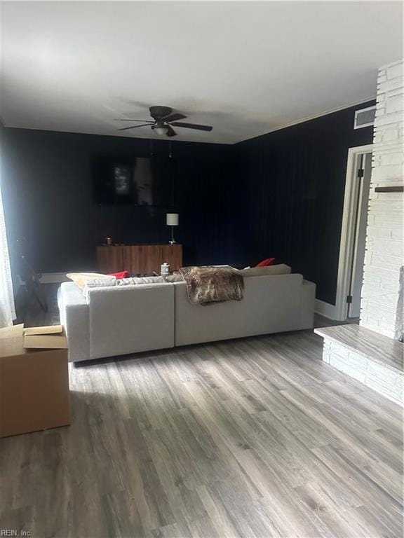 living room featuring ceiling fan and hardwood / wood-style floors