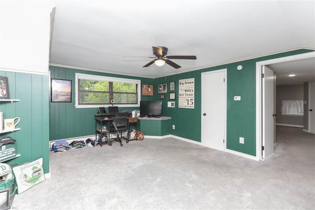 carpeted office space with ceiling fan and crown molding