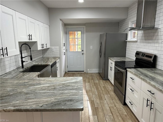 1049 Brandon Ave, Norfolk, VA 23507 - kitchen featuring appliances with stainless steel finishes, wall chimney range hood, light stone counters, white cabinetry, and decorative backsplash