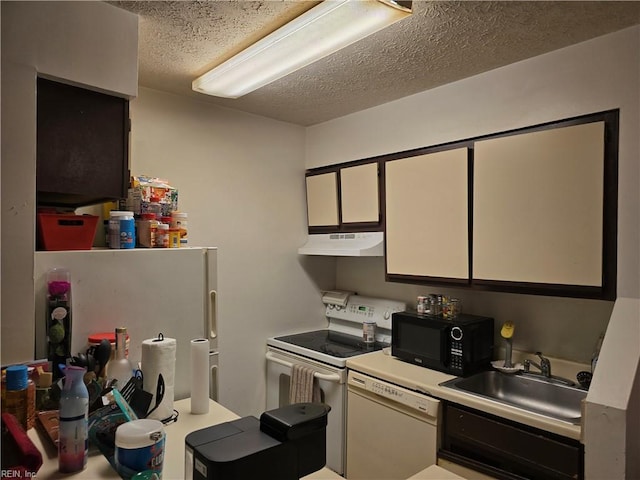 kitchen with white cabinets, a textured ceiling, white appliances, and sink