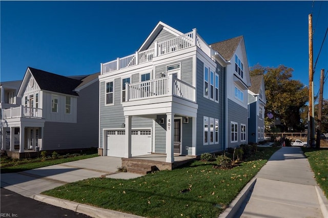 multi unit property with a balcony, a front lawn, and a garage