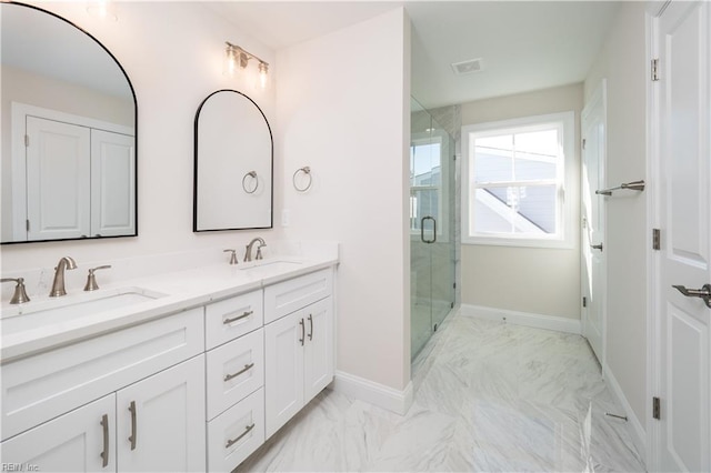 bathroom with a shower with door and vanity