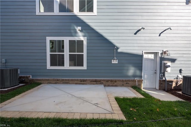 back of property with cooling unit and a patio area