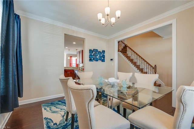 dining space featuring a notable chandelier, ornamental molding, and dark wood-type flooring