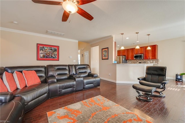 living room featuring dark hardwood / wood-style floors, ceiling fan, and crown molding