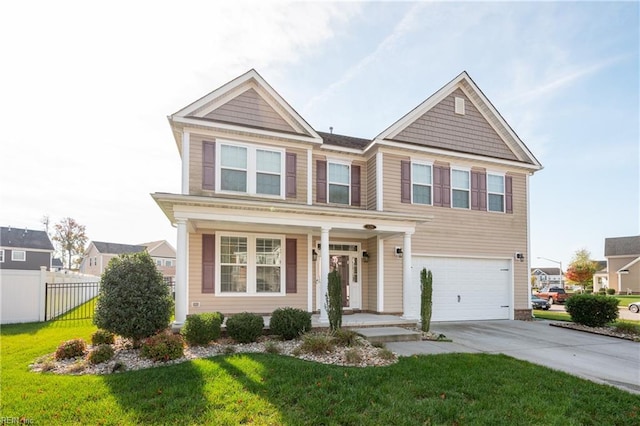 view of front of house with covered porch, a garage, and a front lawn