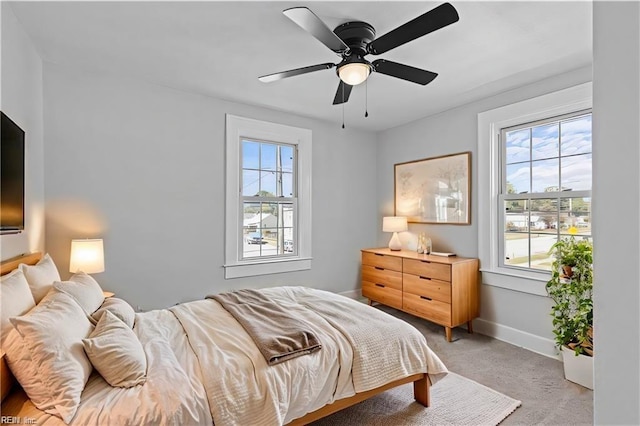 bedroom featuring light carpet and ceiling fan