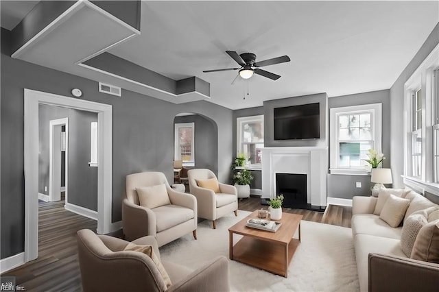 living room with dark hardwood / wood-style floors and ceiling fan