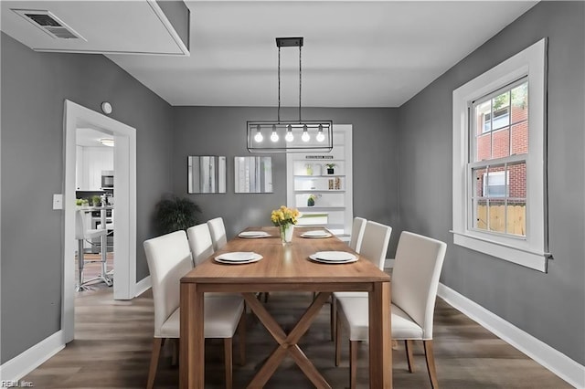 dining room with dark hardwood / wood-style floors