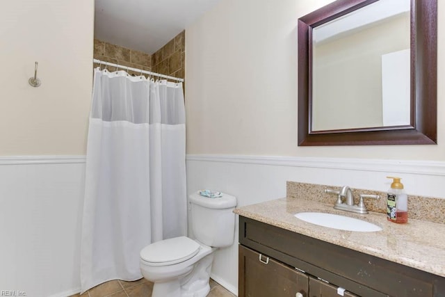 bathroom featuring tile patterned floors, vanity, toilet, and walk in shower