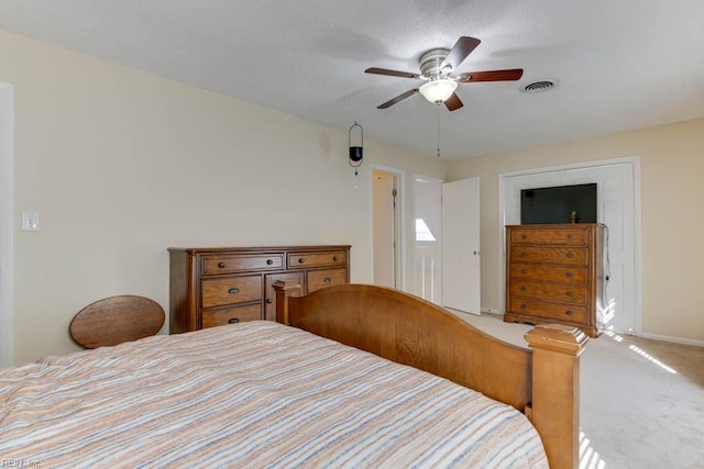 bedroom with carpet, a textured ceiling, and ceiling fan