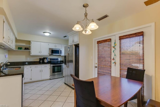 kitchen featuring a chandelier, appliances with stainless steel finishes, white cabinetry, and sink