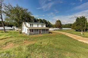 back of property featuring a lawn