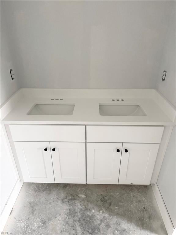 bathroom featuring vanity and concrete flooring