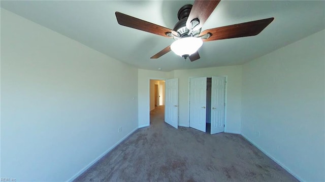 unfurnished bedroom featuring ceiling fan and carpet floors