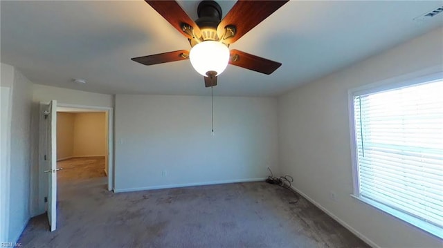 carpeted spare room with ceiling fan