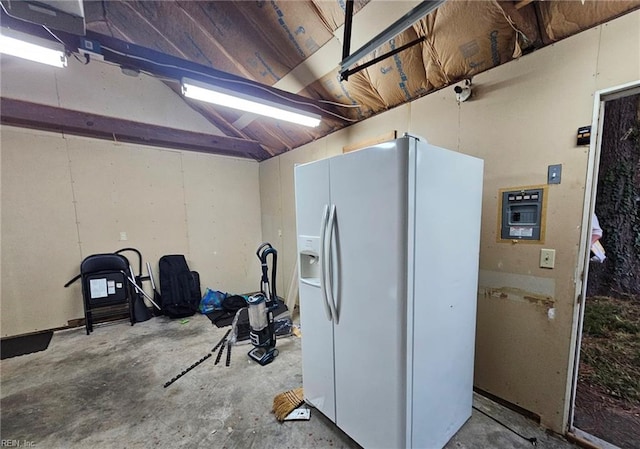 interior space with white fridge with ice dispenser