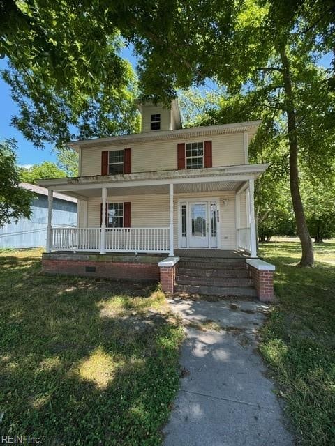 view of front facade with a front lawn and a porch