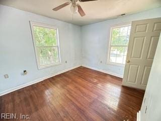 empty room with dark hardwood / wood-style floors and ceiling fan