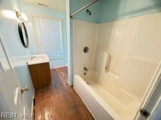 bathroom featuring hardwood / wood-style floors, vanity, and bathtub / shower combination