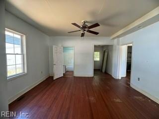 unfurnished bedroom with ceiling fan and dark wood-type flooring