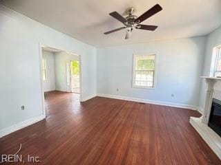 unfurnished living room with ceiling fan and dark hardwood / wood-style floors