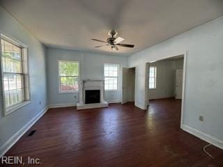 unfurnished living room featuring dark hardwood / wood-style flooring, a wealth of natural light, and ceiling fan