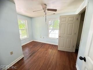 unfurnished bedroom with ceiling fan and dark hardwood / wood-style flooring