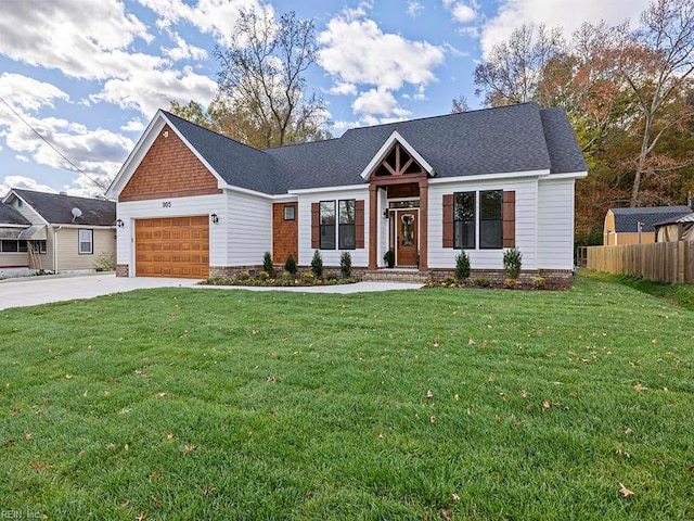 view of front of house with a front yard and a garage