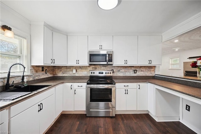 kitchen featuring plenty of natural light, white cabinetry, sink, and appliances with stainless steel finishes