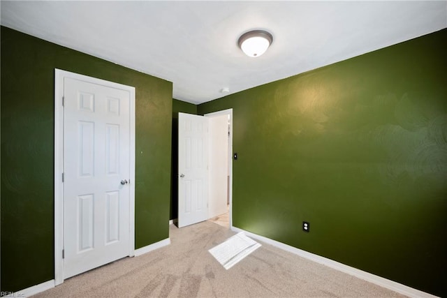 unfurnished bedroom with light colored carpet