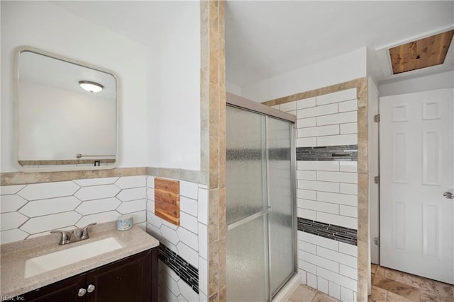 bathroom featuring tile walls, vanity, and an enclosed shower