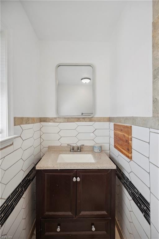 bathroom featuring vanity and tile walls