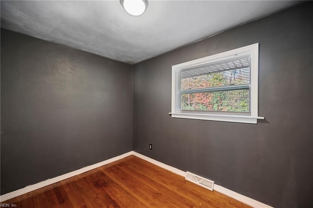 spare room with hardwood / wood-style floors