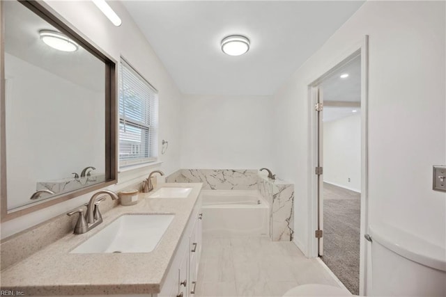 bathroom with vanity, toilet, and a bathtub