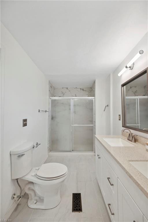 bathroom with a shower with door, vanity, and toilet