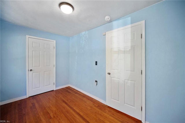 unfurnished room with hardwood / wood-style flooring